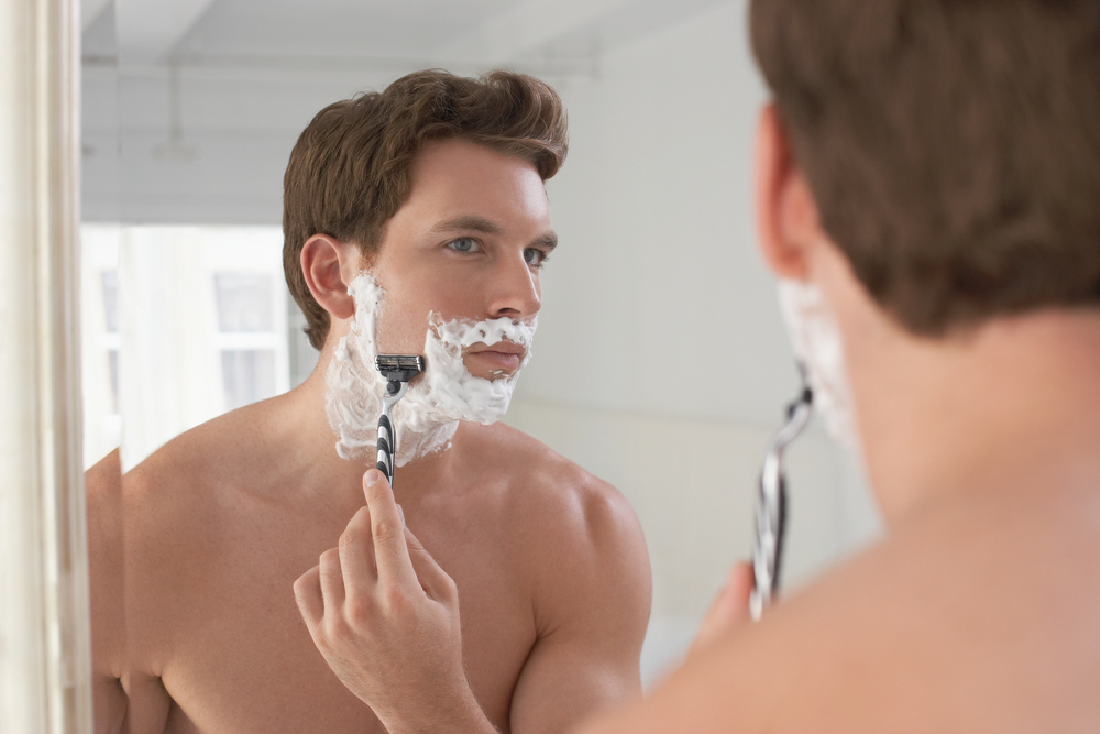Man Shaving in a Mirror